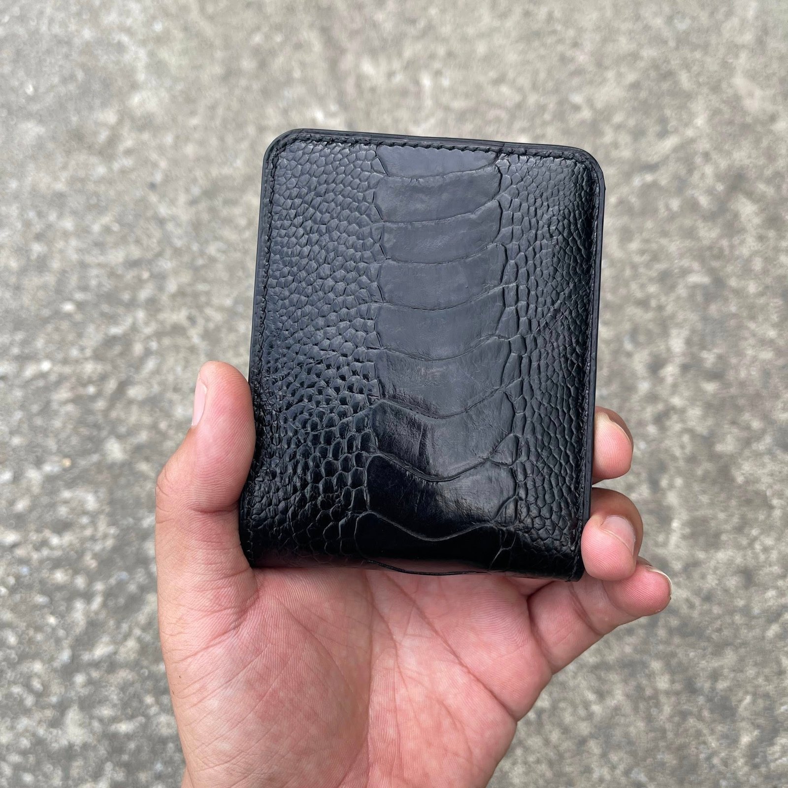 Black ostrich leather bifold wallet